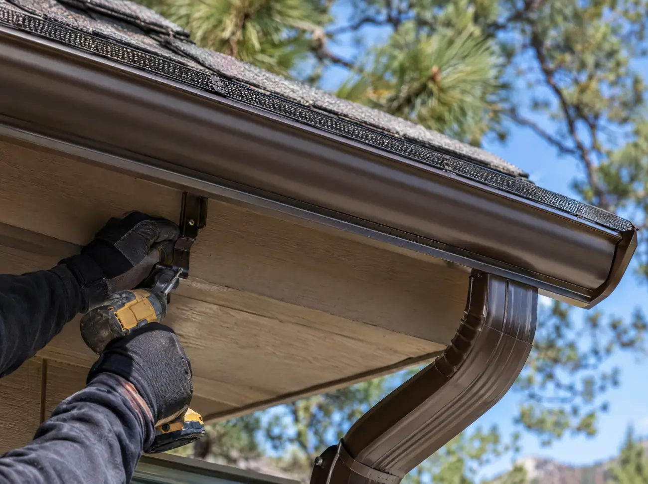 Castle Rock gutters: fastening a new seamless gutter and downspout