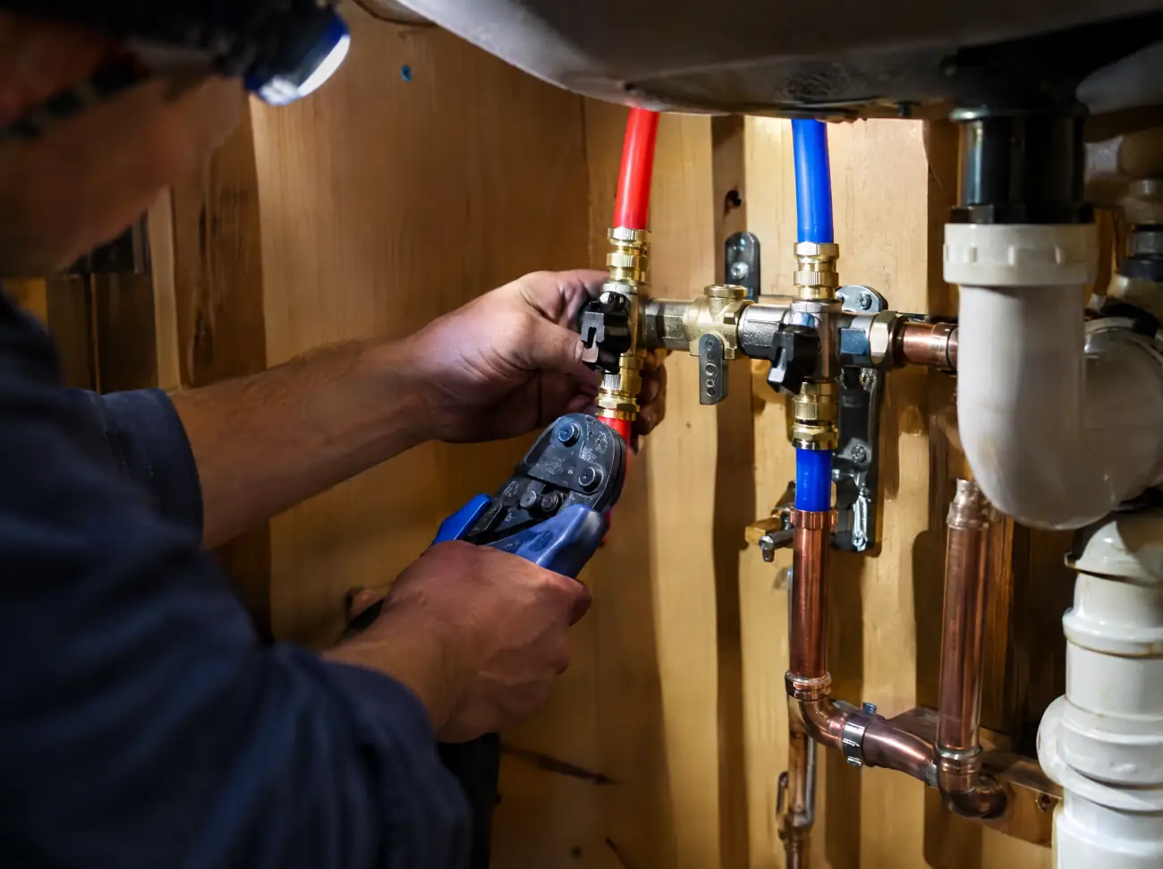 Castle Rock plumbing: connecting new supply lines under a kitchen sink Castle Rock plumbing: connecting new supply lines under a kitchen sink